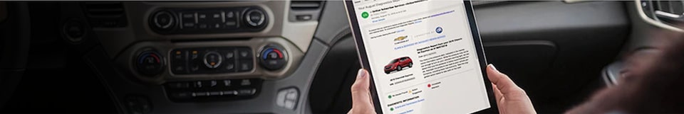 Woman viewing vehicle diagnostics with Connected Services.