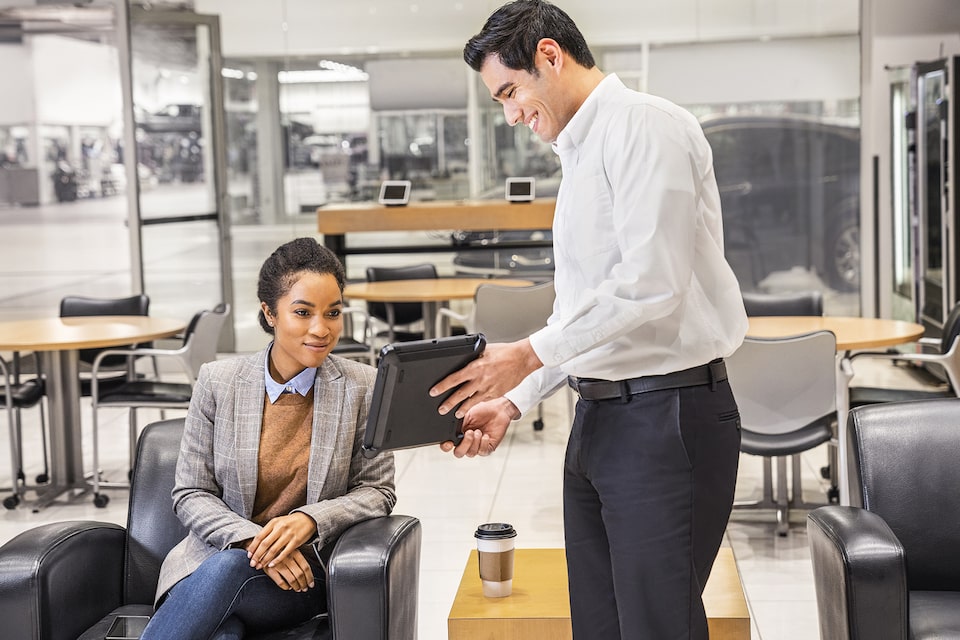 Certified Service representative discussing with an owner a comprehensive assessment of her vehicle