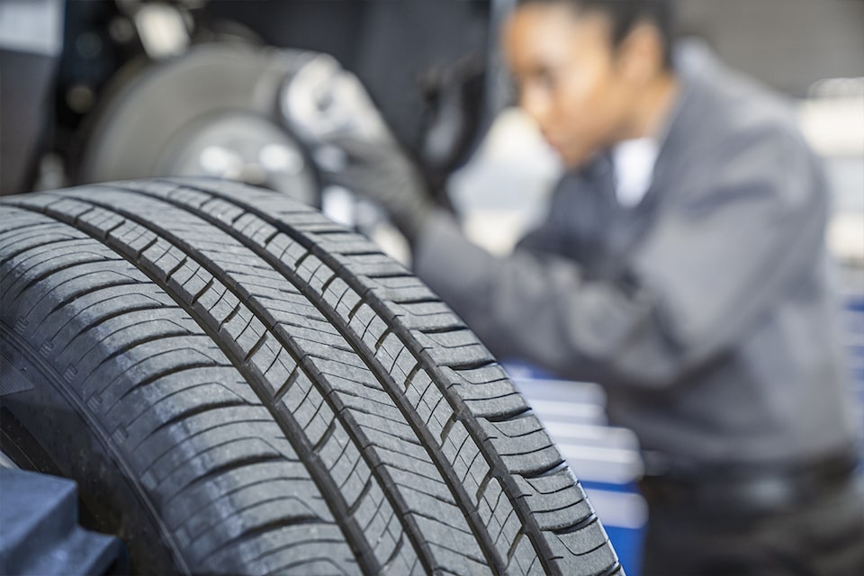 A Certified Service technician changing a tire